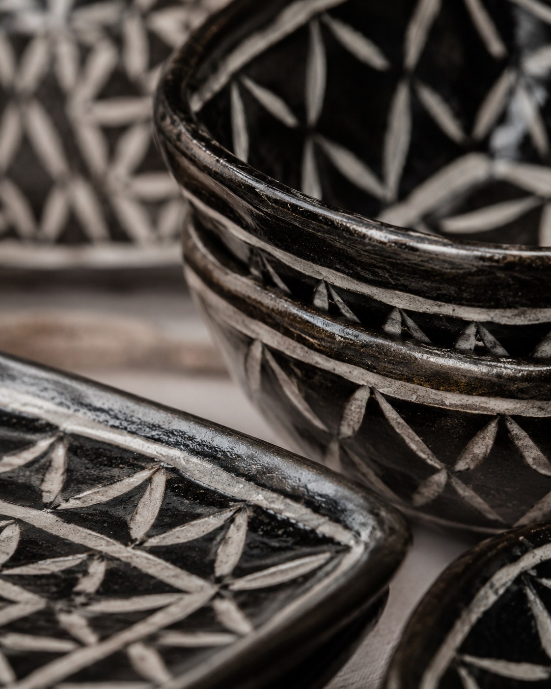 Close-up of hand-finished black and ivory geometric tableware